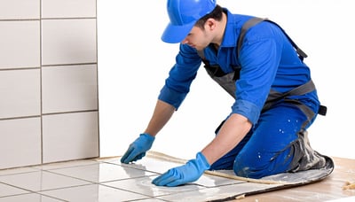 Installer applying Sofita adhesive to tiles